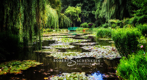 Lush greenery creates a sublime feeling in Impressionist Claude Monet's garden pond near Giverny, France.